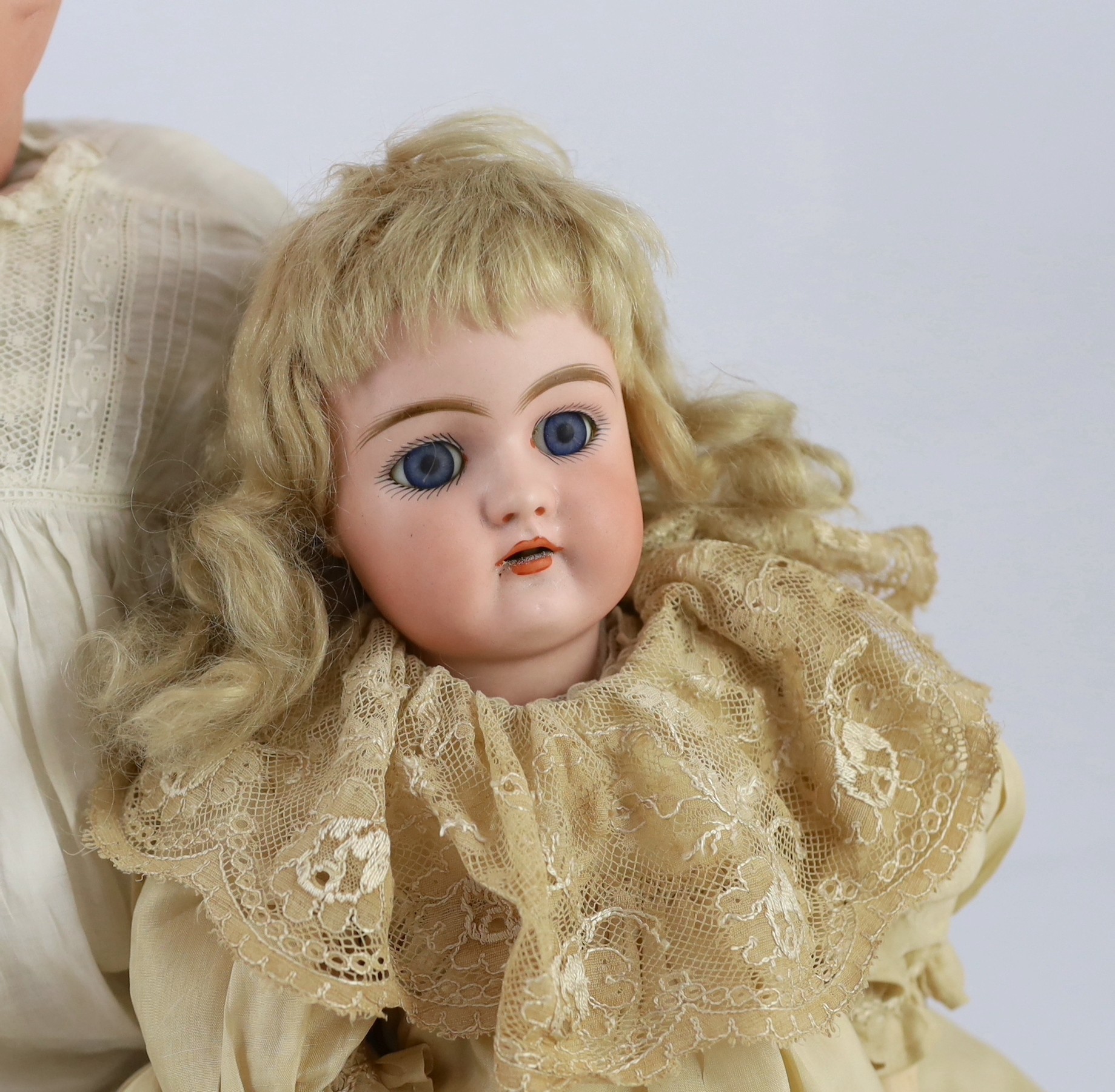 A Heinrich Handwerck bisque doll, German, circa 1900, 18in. and 23in. resp.